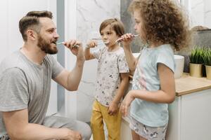 Photo by Pavel Danilyuk: https://www.pexels.com/photo/a-father-brushing-his-teeth-with-his-kids-inside-the-bathroom-8762977/