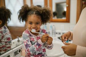 Photo by RODNAE Productions: https://www.pexels.com/photo/curly-haired-girl-brushing-teeth-10566470/
