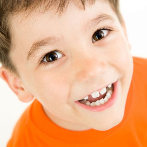 smiling kid in orange shirt