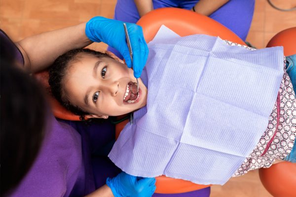child having teeth examined